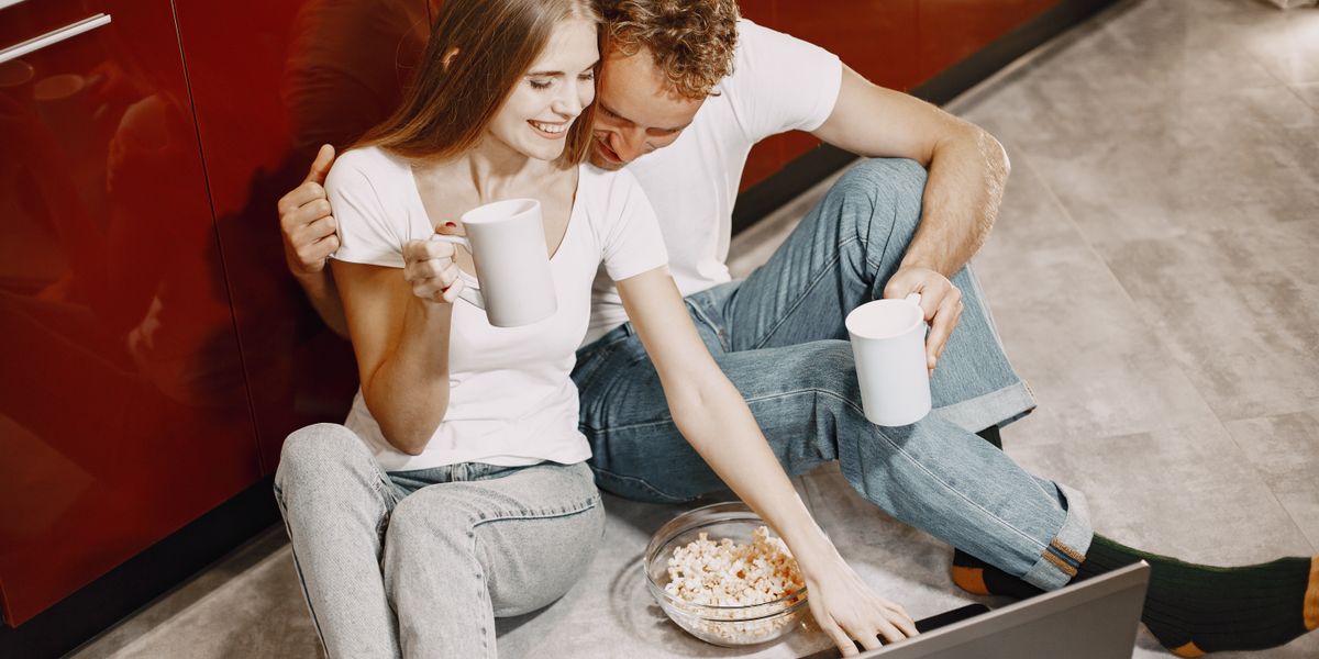 A couple watching a film together on a laptop at home